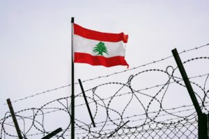 علم لبنان بين الأسلاك الشائكة
